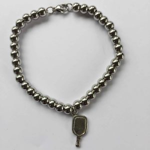 Image of a bracelet with a pickleball paddle charm.